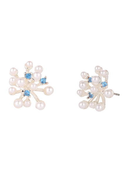 Pair of pearl earrings with blue gemstones on a white background