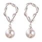 Pair of silver earrings with pearl drops on a white background