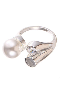 Silver ring with a pearl and gemstone on a white background