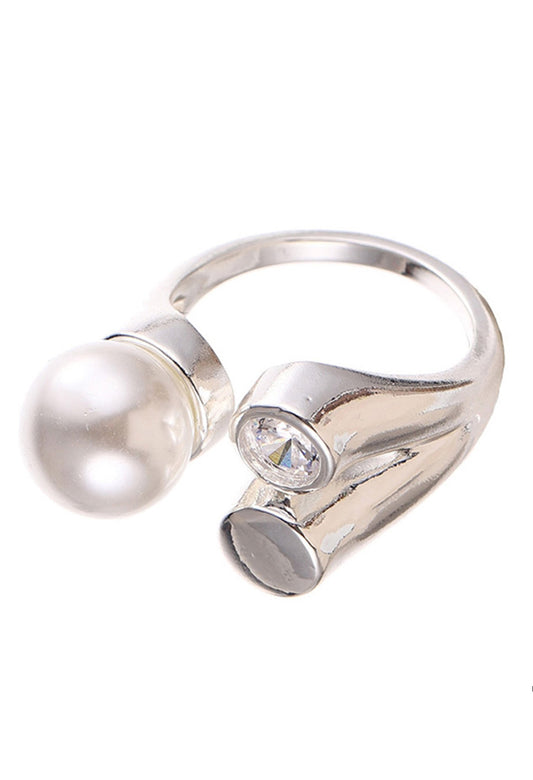 Silver ring with a pearl and gemstone on a white background