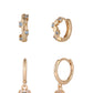 Set of gold hoop earrings and a pair of gold hoop earrings with gemstones on a white background