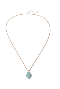 Necklace with a green teardrop pendant on a white background