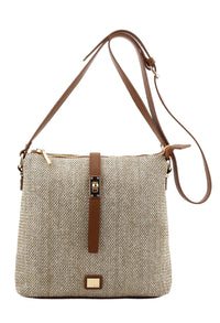 Beige woven handbag with brown leather straps on a white background