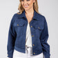 Woman wearing a blue denim jacket on a white background
