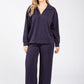 Woman wearing a navy tracksuit on a white background