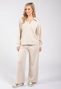 Woman wearing a beige outfit on a white background