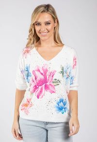 woman wearing a soft knit pullover with floral design