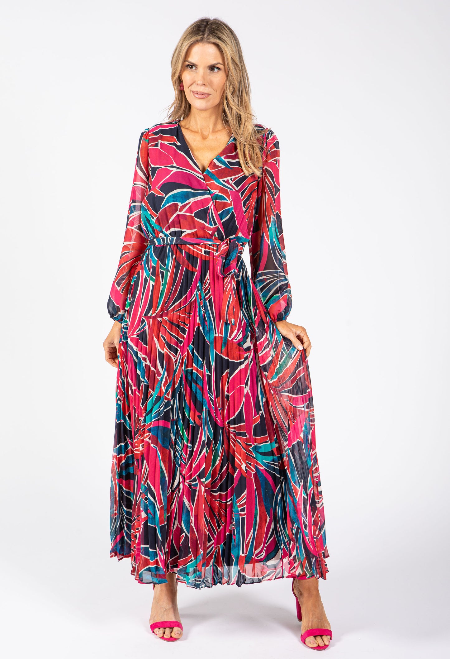 Woman wearing a colorful patterned dress on a white background