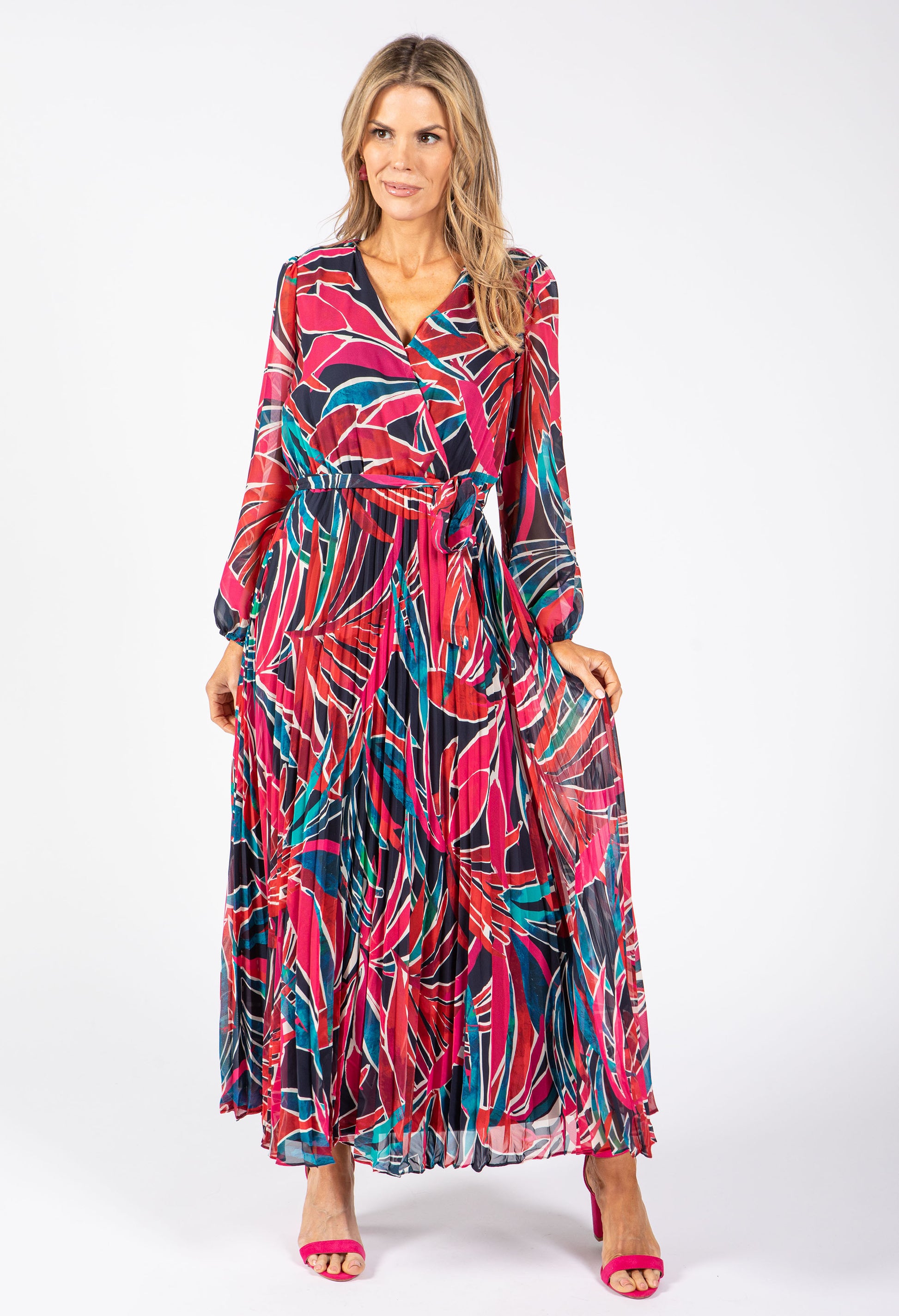 Woman wearing a colorful patterned dress on a white background