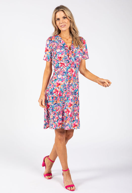 Woman wearing a colorful floral dress on a white background