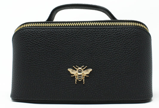 Black leather cosmetic bag with a gold bee emblem on a white background