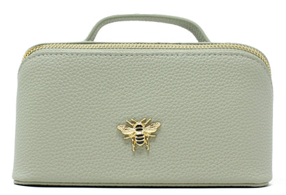 Light green cosmetic bag with a gold bee emblem on a white background