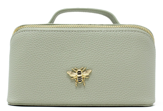 Light green cosmetic bag with a gold bee emblem on a white background