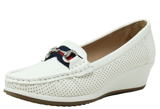 Navy blue loafer shoe with a white sole on a light gray background