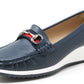 Navy blue loafer shoe with a white sole on a light gray background