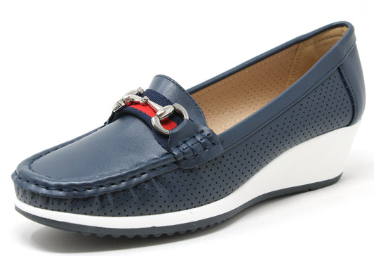 Navy blue loafer shoe with a white sole on a light gray background