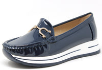 Navy blue patent leather loafer with a white sole on a white background