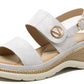 White sandal with a gold buckle on a white background