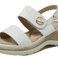 White sandal with gold buckle on a white background