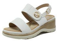 White sandal with gold buckle on a white background
