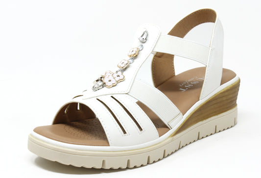 Beige sandal with embellishments on a white background