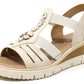 Beige sandal with embellishments on a white background