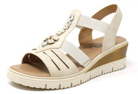 Beige sandal with embellishments on a white background