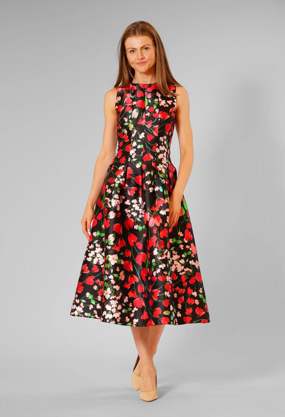 Woman wearing a floral dress on a gray background