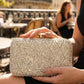 Person holding a sparkling clutch in an outdoor setting