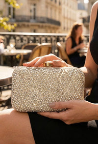 Person holding a sparkling clutch in an outdoor setting