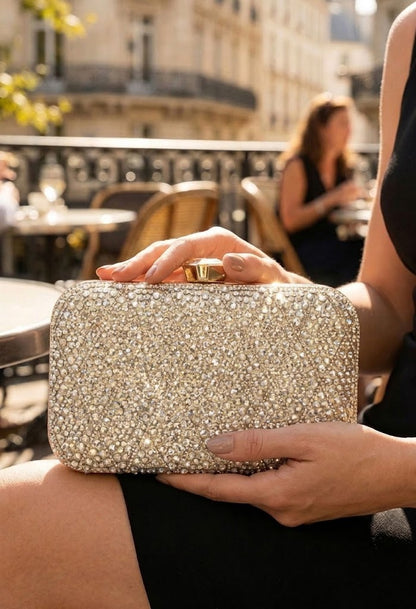 Person holding a sparkling clutch in an outdoor setting
