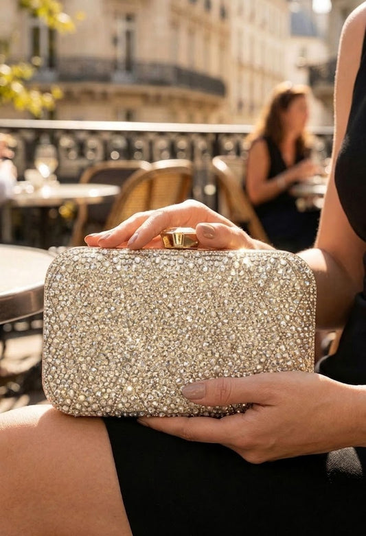 Person holding a sparkling clutch in an outdoor setting