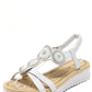 White sandal with decorative straps on a white background