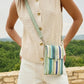 Person wearing a beige sleeveless vest and white shorts with a green crossbody bag outdoors.