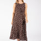 Woman wearing a brown dress with white polka dots on a white background
