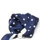 Navy blue scarf with white polka dots and a gold buckle on a white background