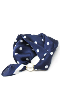 Navy blue scarf with white polka dots and a gold buckle on a white background