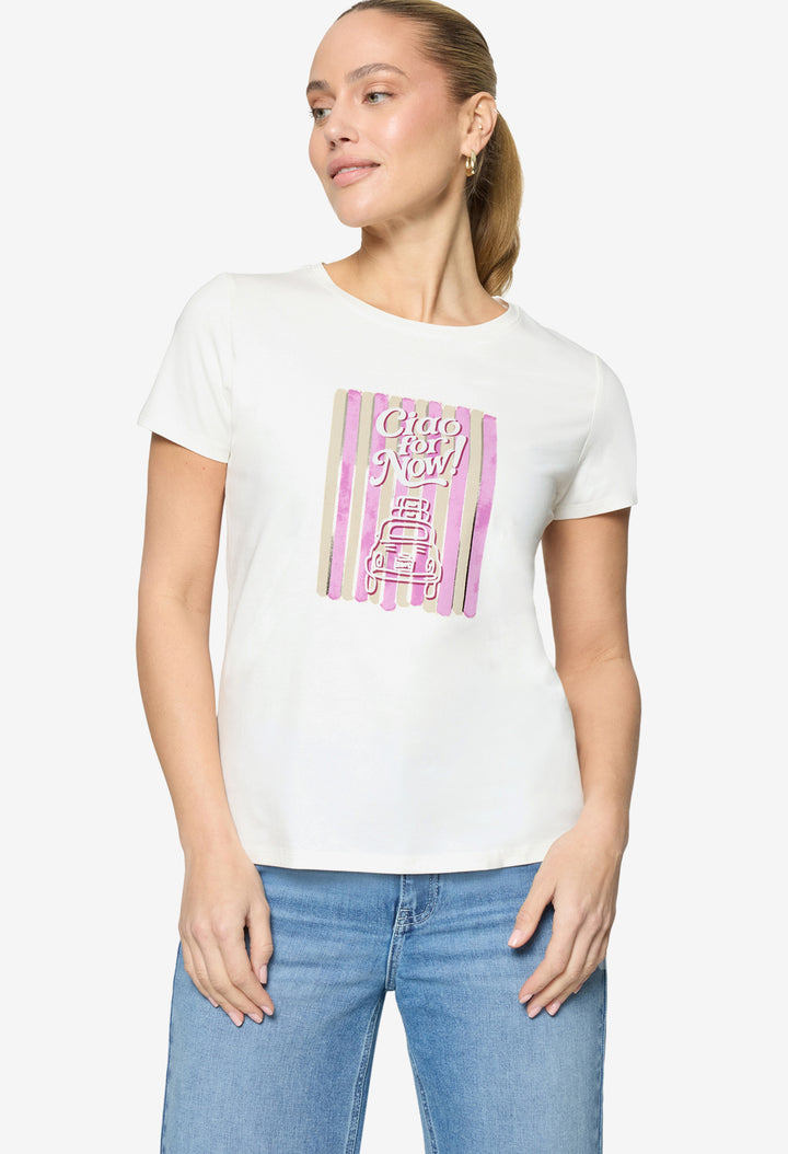Woman wearing a white t-shirt with a colorful graphic design on a plain background