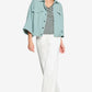 Woman wearing a light blue denim jacket, striped shirt, and white pants on a white background