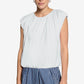 Woman wearing a white sleeveless top and blue striped pants on a white background