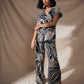 Woman wearing a zebra print outfit against a beige background
