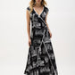Woman wearing a black and white patterned dress on a white background