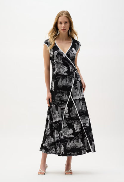 Woman wearing a black and white patterned dress on a white background