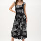 Woman wearing a black and white patterned jumpsuit on a white background
