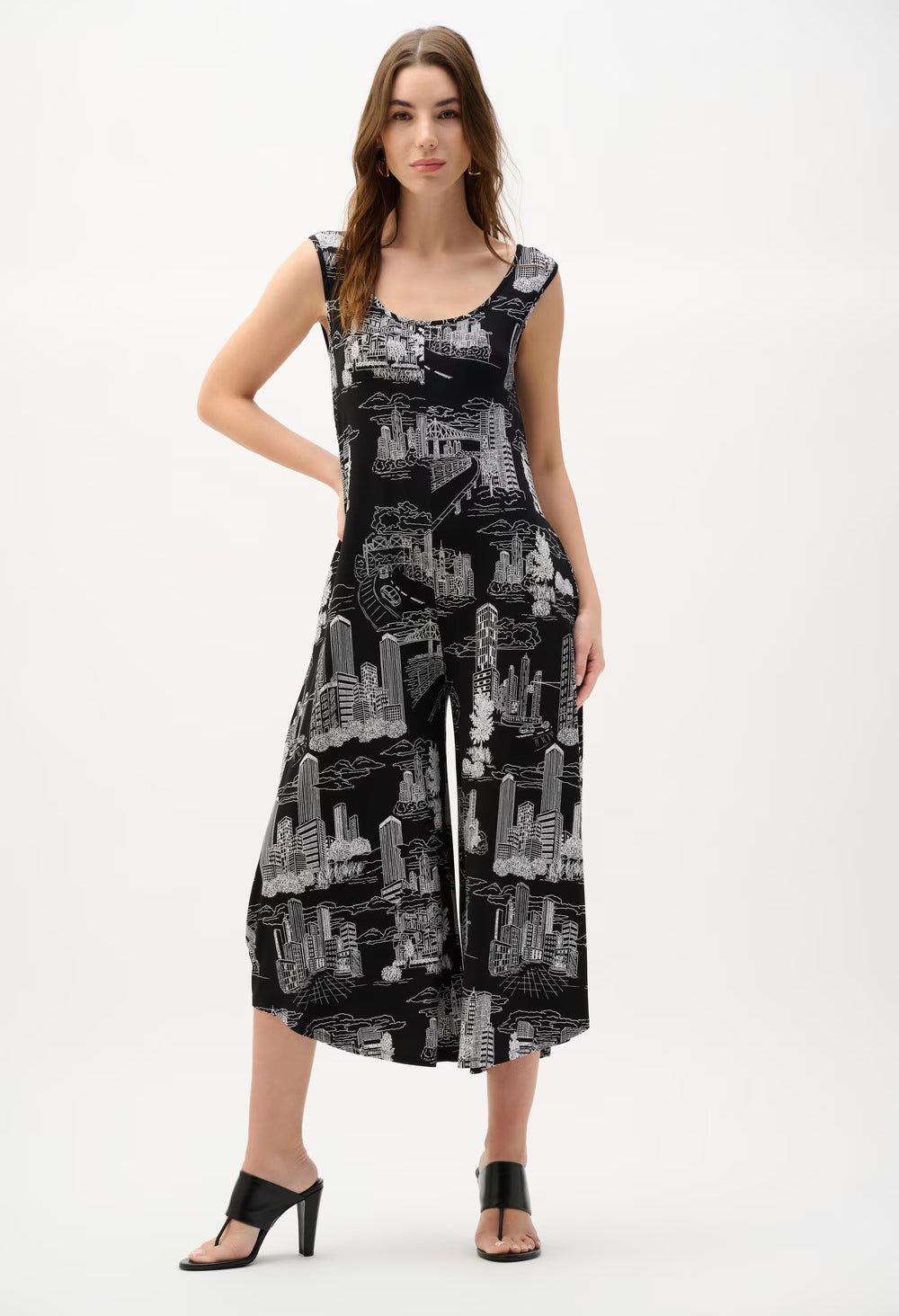 Woman wearing a black and white patterned jumpsuit on a white background