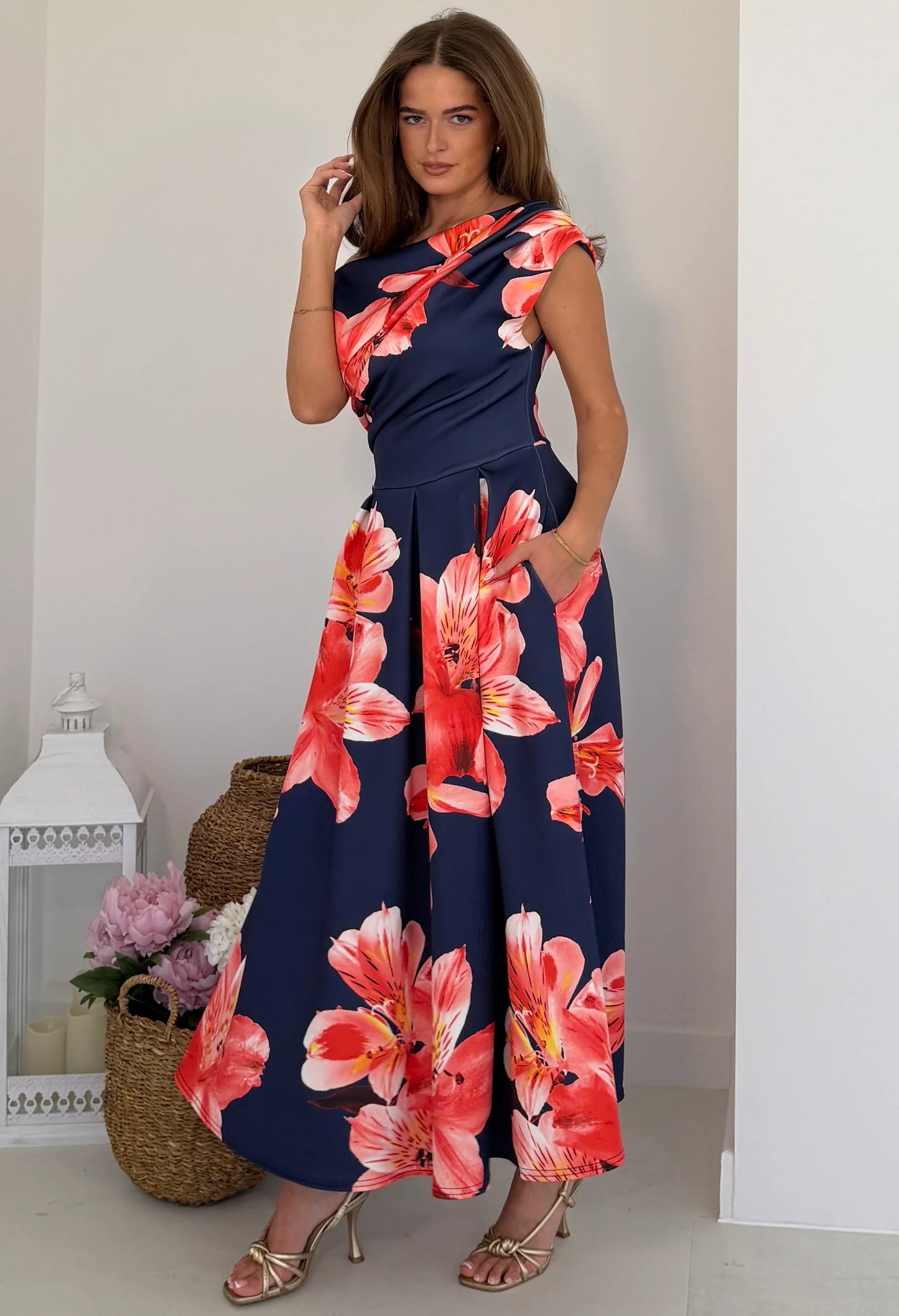 Three-quarter view of Betty midi dress showing asymmetric neckline and short sleeve