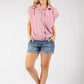 Woman wearing a red and white checkered shirt and denim shorts on a white background