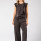 Woman wearing a brown jumpsuit on a white background