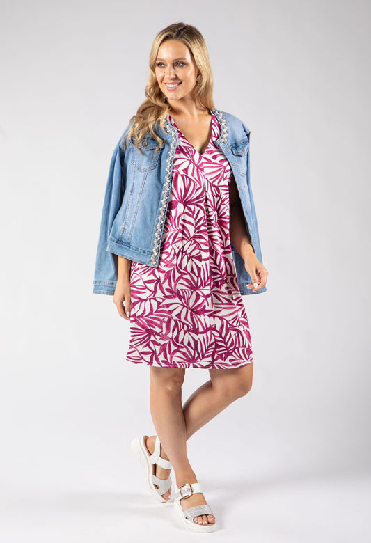 Woman wearing a blue and white patterned dress on a white background