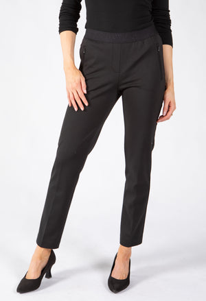 A model wearing slim-fit black trousers with a textured waistband. Features side zip pockets. 